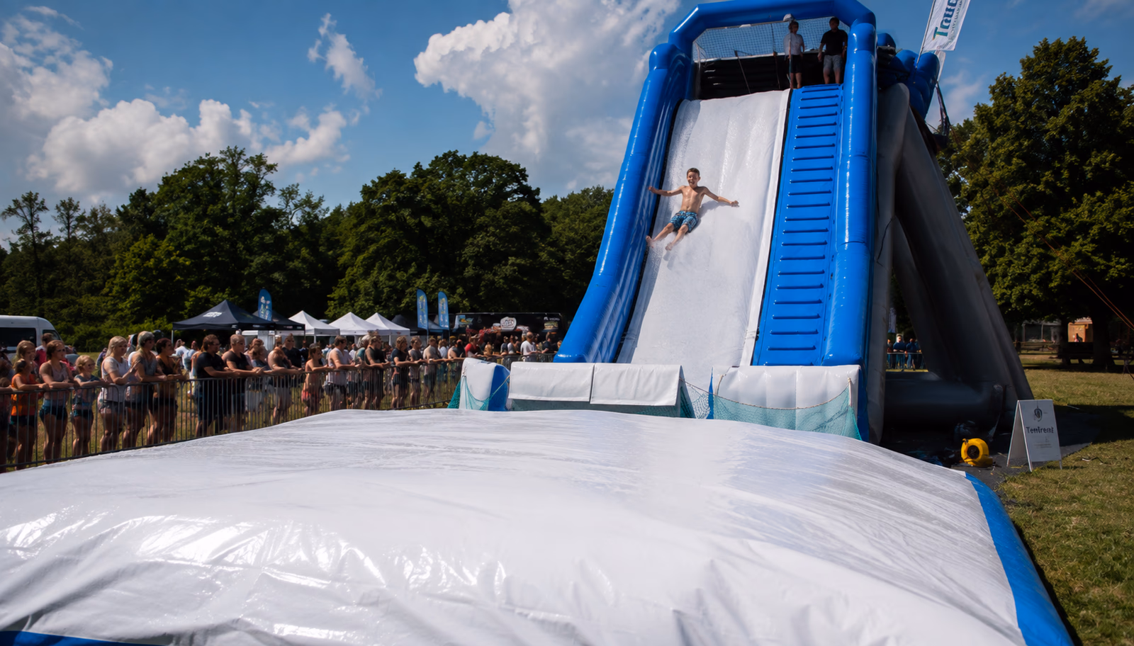 Person body sliding down a Pearljump inflatable slide